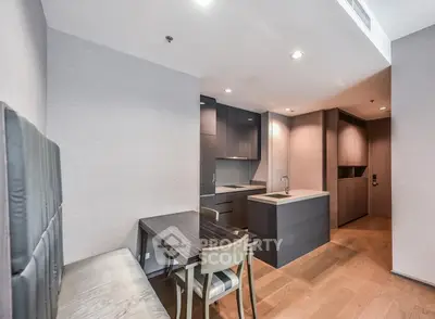 Modern kitchen and dining area with sleek design and wood flooring
