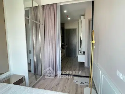 Modern bedroom with mirrored closet and stylish decor