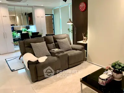 Modern living room with cozy seating and stylish decor in a contemporary apartment.