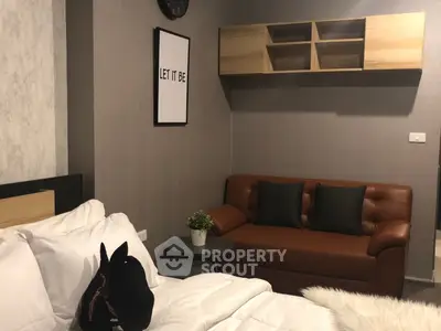 Cozy bedroom with stylish decor and comfortable seating area