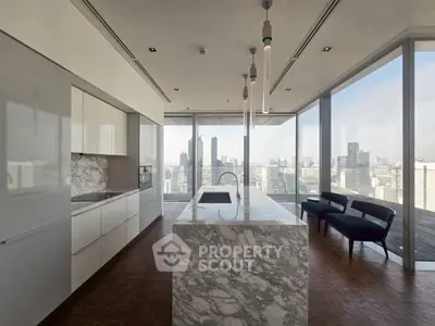 Luxurious modern kitchen with marble island and stunning city view