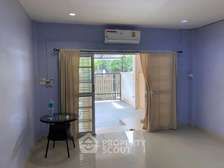 Spacious living room with air conditioning and patio access