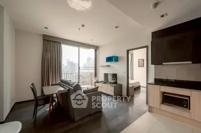 Modern apartment living room with city view, open kitchen, and stylish furnishings.
