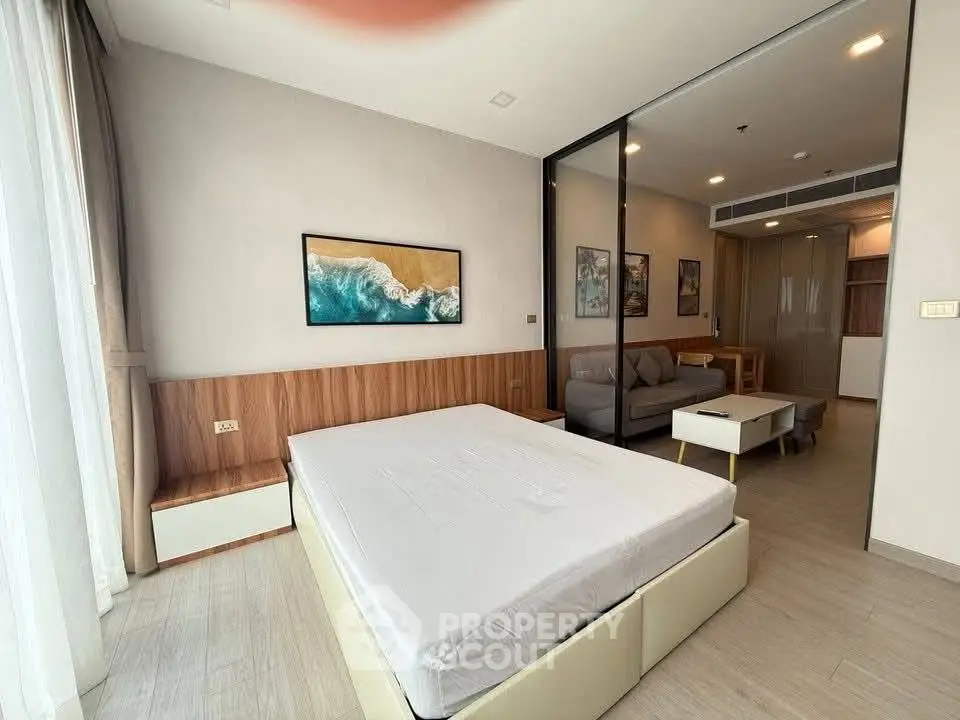 Modern bedroom with stylish decor and cozy seating area in a contemporary apartment.