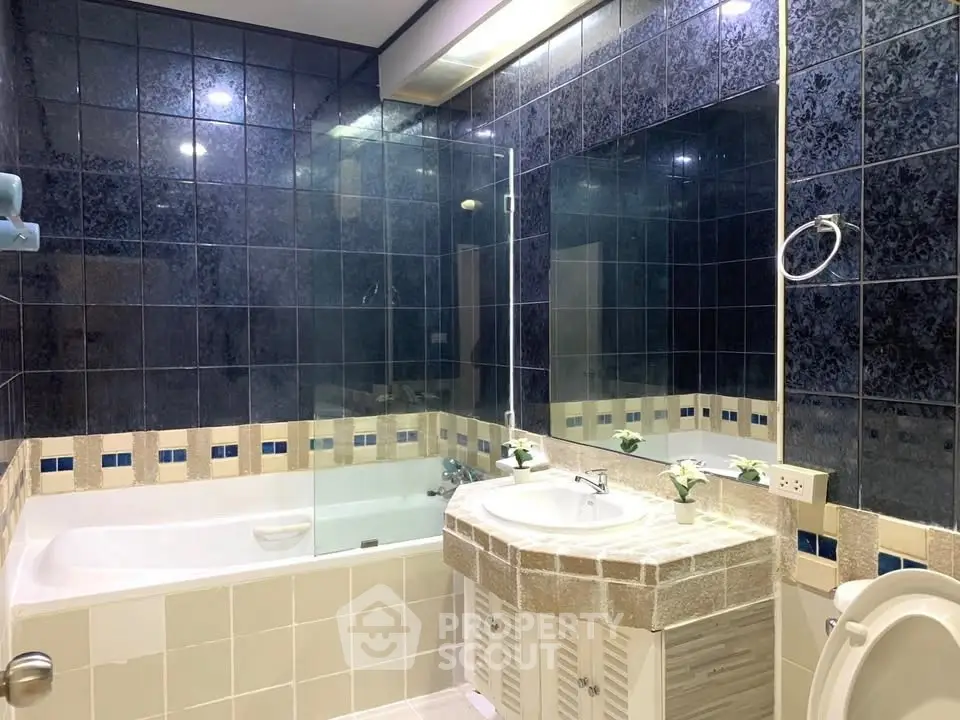 Luxurious bathroom with elegant tile design and spacious bathtub