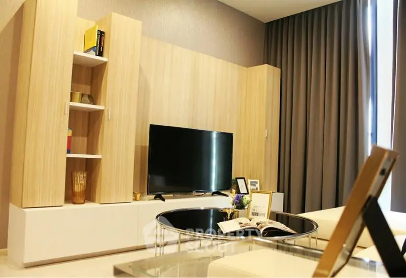 Modern living room with stylish wooden entertainment unit and large TV, perfect for relaxation.