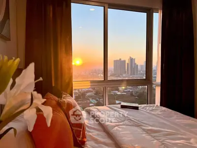 Stunning bedroom with breathtaking city view at sunset, perfect for urban living.