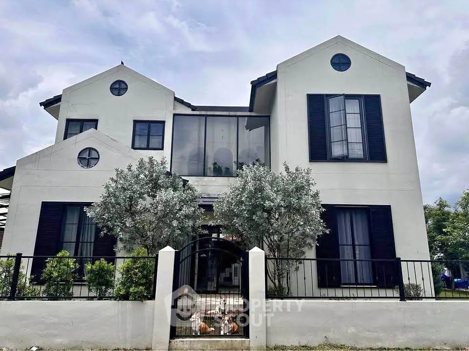 Elegant two-story house with modern architecture and lush greenery