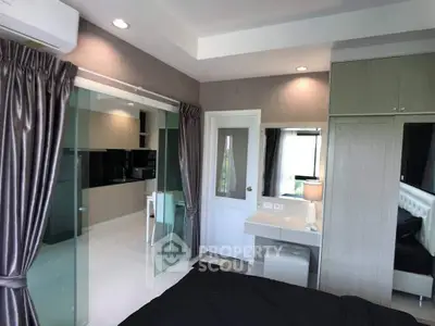 Modern bedroom with glass partition and sleek furnishings