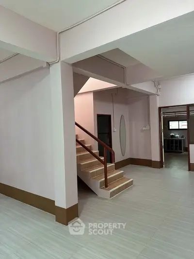 Spacious interior with staircase and modern design, perfect for family living.