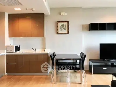 Modern open-layout kitchen and dining area with sleek cabinetry and stylish decor.