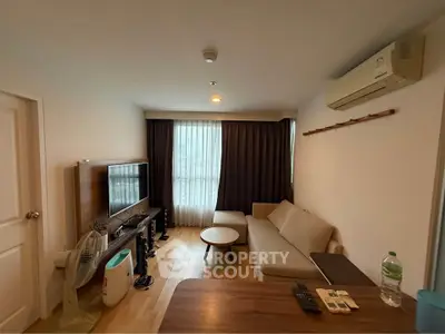 Cozy living room with modern furniture and natural light, perfect for relaxation and entertainment.