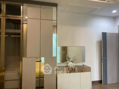 Modern bedroom with sleek wardrobe and vanity mirror