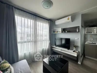Modern living room with large window, air conditioning, and sleek furniture