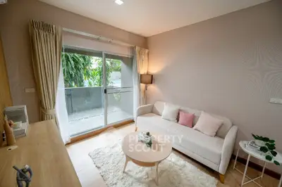 Cozy living room with modern decor and balcony view