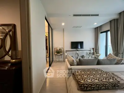 Modern living room with stylish decor and large windows for natural light.