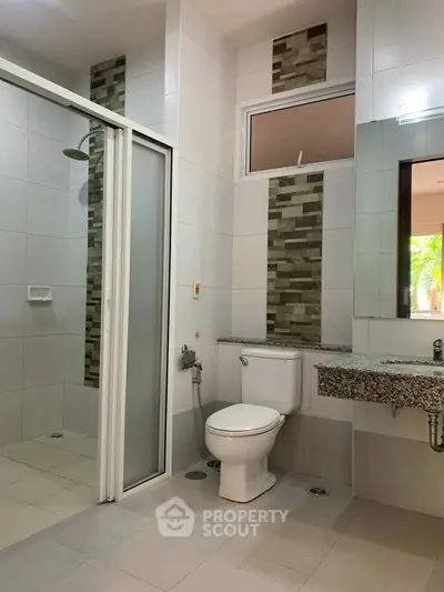 Modern bathroom with sleek shower and stylish tile accents, perfect for a contemporary home.