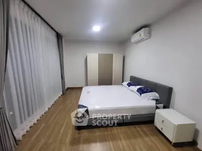 Spacious modern bedroom with large windows and elegant decor