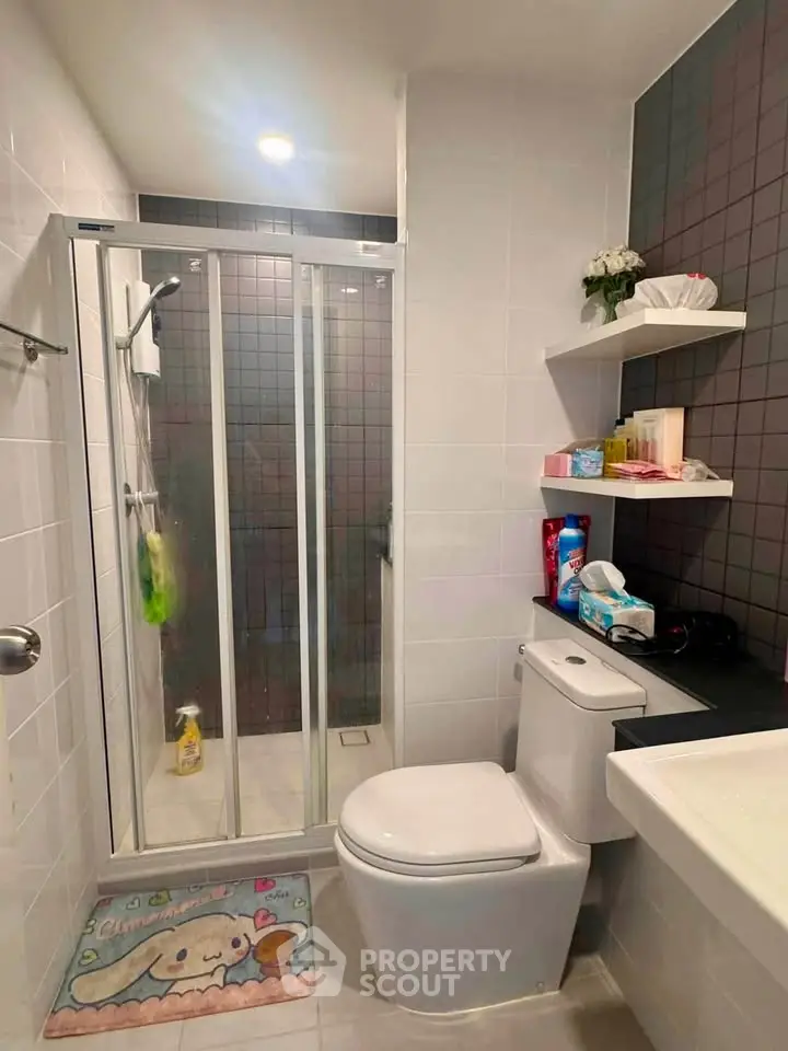 Modern bathroom with glass shower and sleek fixtures in a contemporary home.