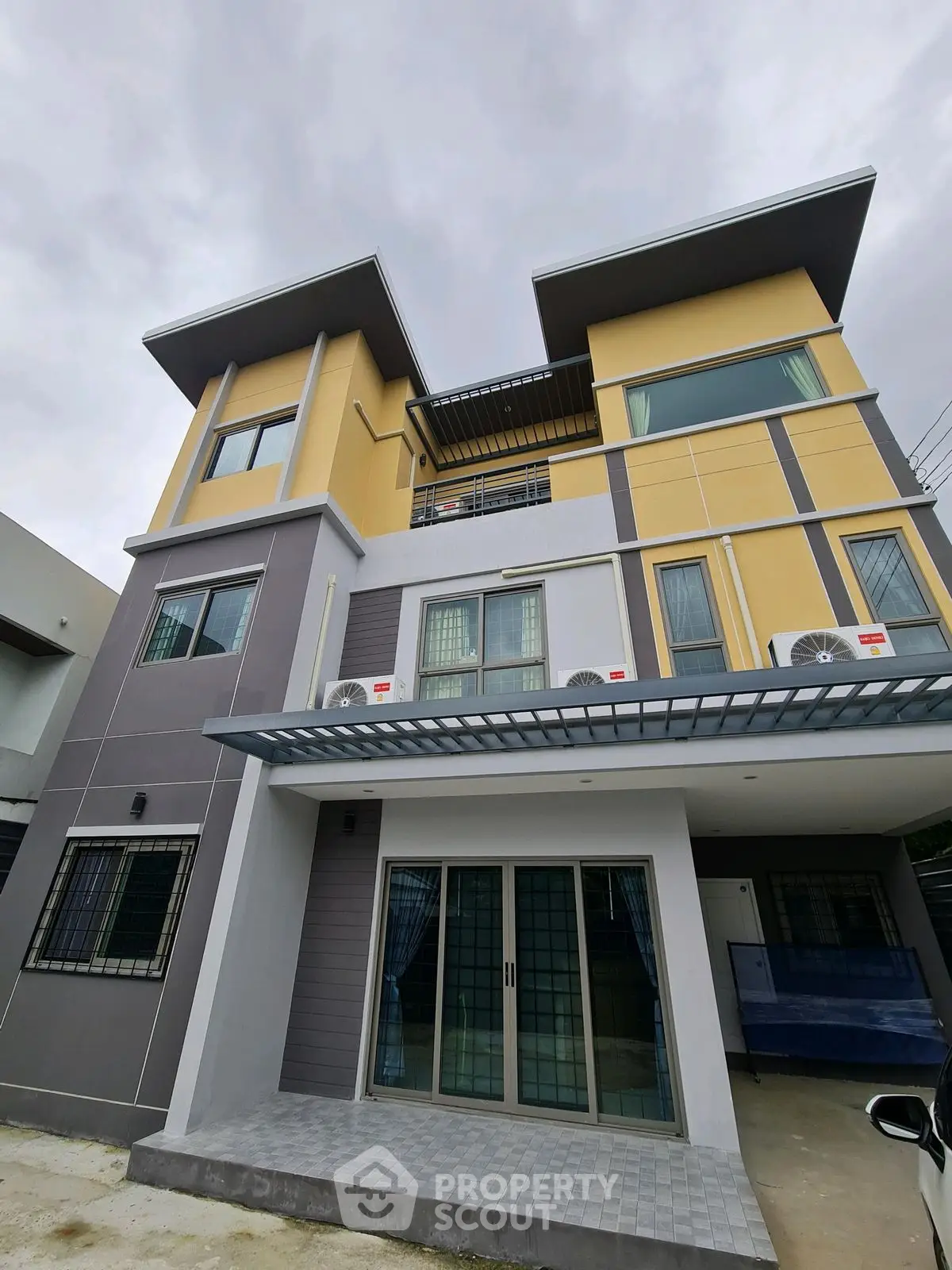 Modern multi-story house with stylish facade and large windows
