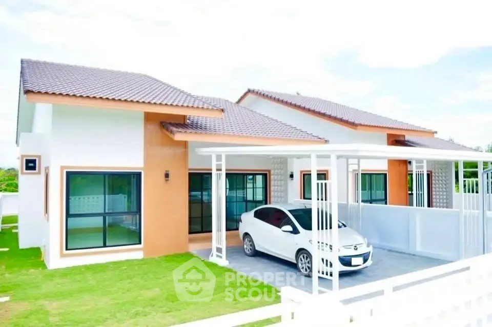 Modern single-story house with carport and lush green lawn