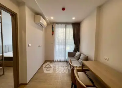 Modern living room with natural light, featuring a cozy sofa and dining area, perfect for urban living.