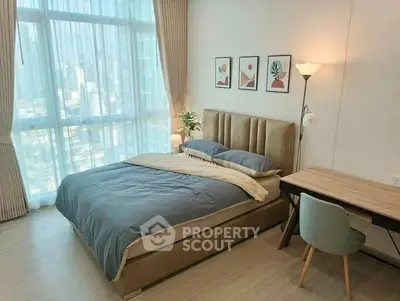 Modern bedroom with large window and stylish decor in urban apartment