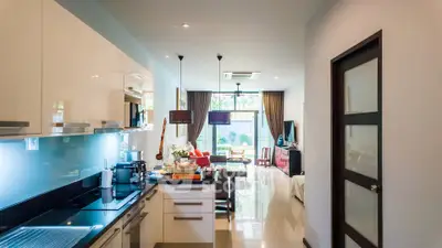 Modern open-layout kitchen and living room with sleek design and natural light.