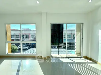 Bright and spacious room with large windows and modern design.