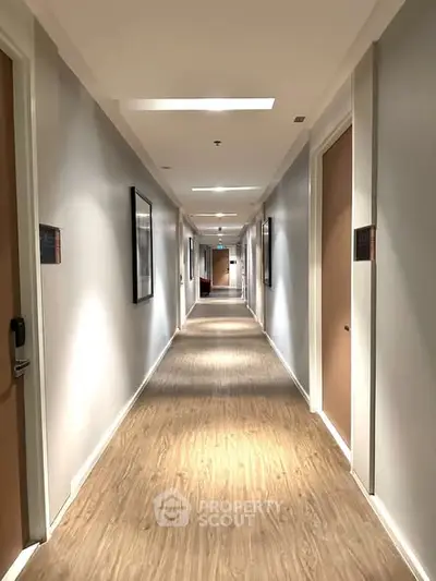 Modern apartment hallway with wooden flooring and elegant lighting