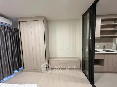 Modern apartment interior with sliding glass doors and sleek kitchen design
