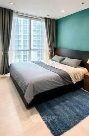 Modern bedroom with large window and stylish decor in urban apartment