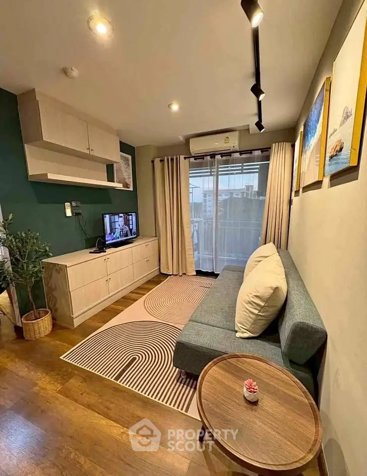 Modern living room with stylish decor and natural light, featuring a cozy sofa and wall-mounted TV.