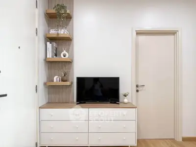 Modern living room with sleek TV stand and decorative shelves