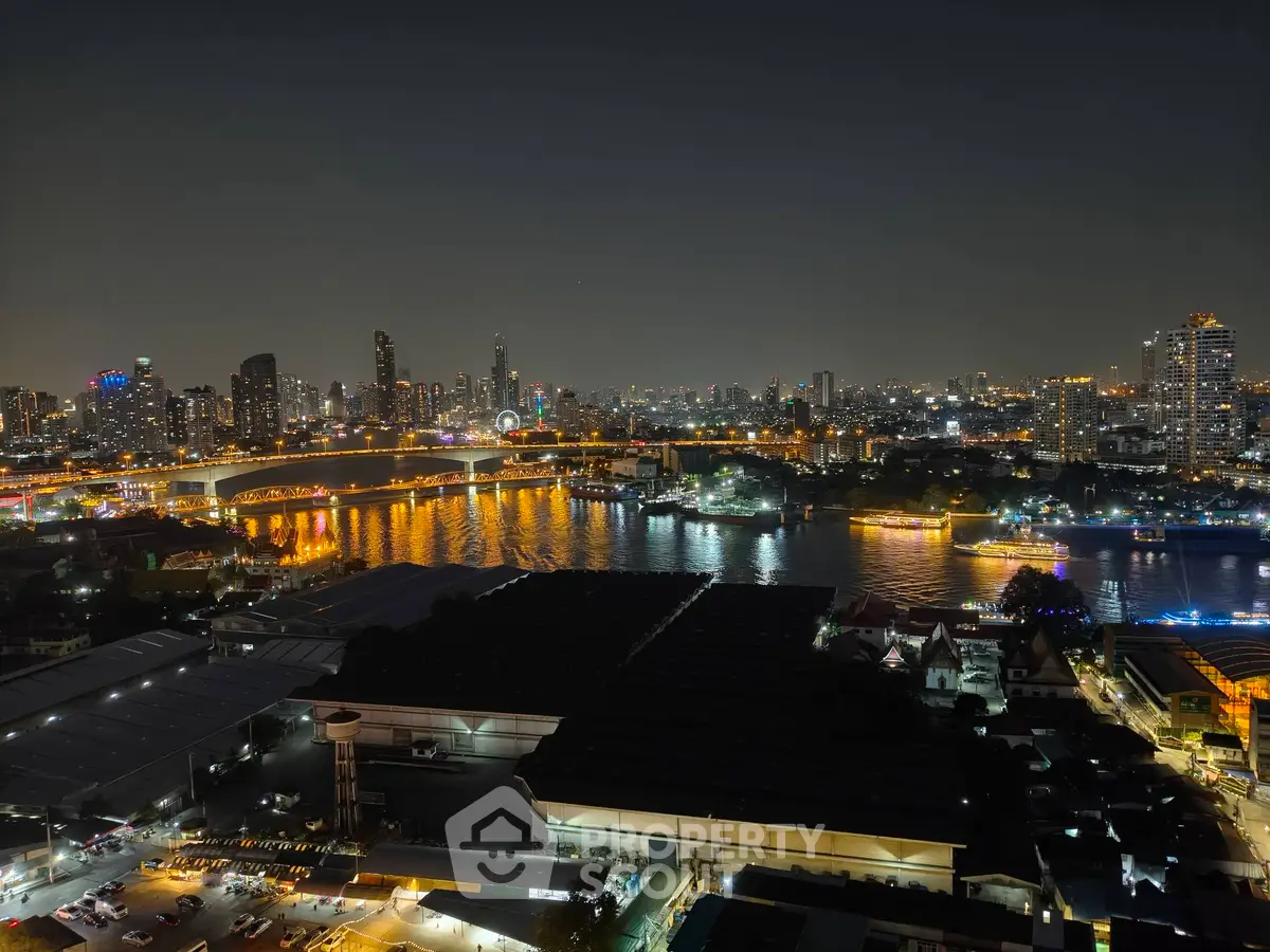 Stunning night view of city skyline and river, showcasing vibrant urban lights and serene water reflections.
