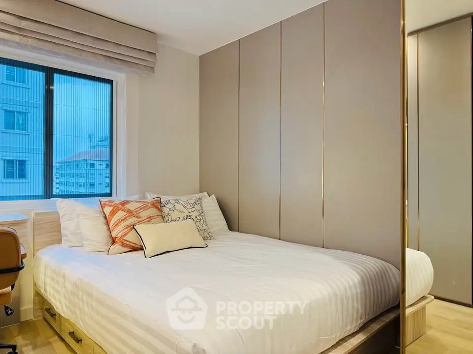 Modern bedroom with stylish decor and large window view