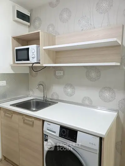 Modern compact kitchen with built-in appliances and stylish wooden cabinetry