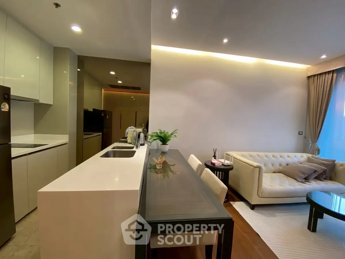 Modern open-layout kitchen and living room with sleek design and cozy ambiance.