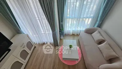Chic and cozy living room with elegant curtains and stylish furniture, perfect for relaxation and entertainment.