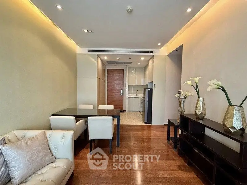 Modern living room with elegant dining area and open kitchen in a stylish apartment.