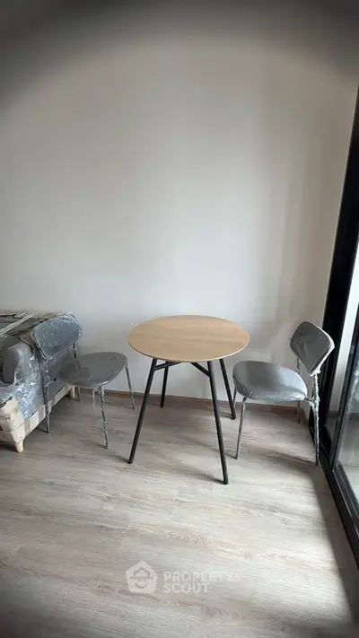 Cozy minimalist corner with round table and chairs in modern apartment