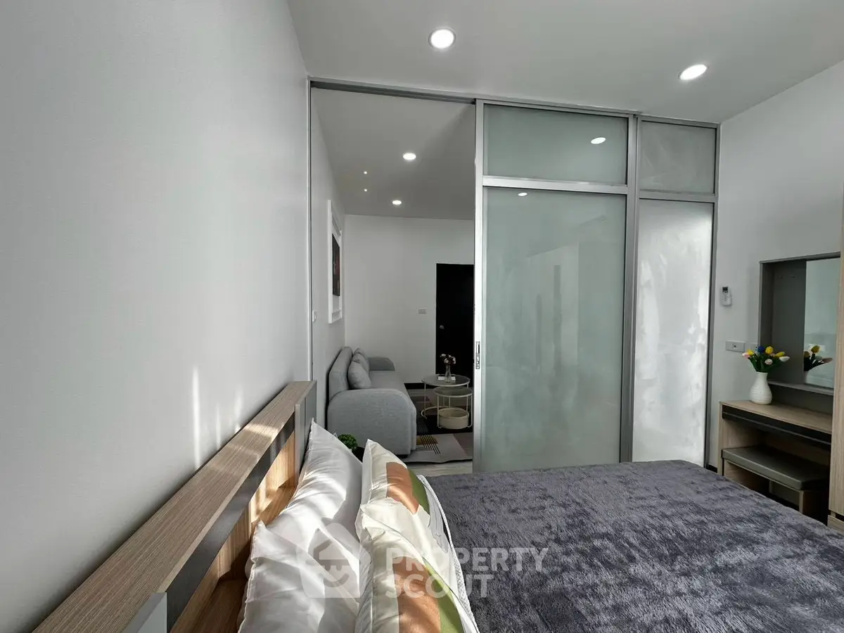 Modern bedroom with sliding glass doors and cozy decor