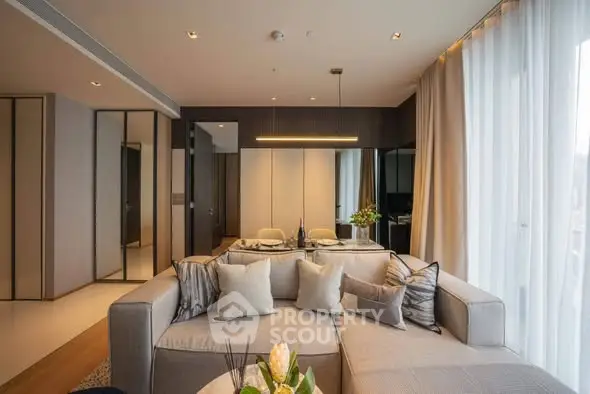 Luxurious modern living room with elegant decor and ample natural light.