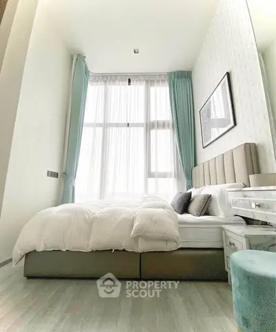 Luxurious bedroom with high ceilings and elegant decor