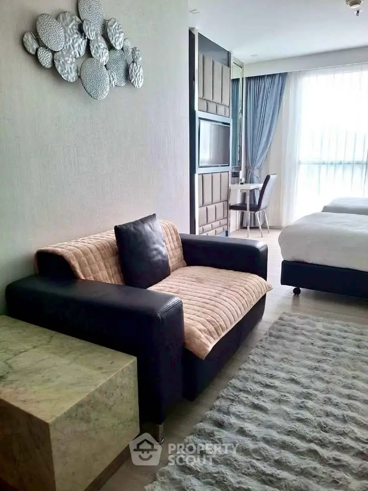 Modern living room with stylish decor and cozy seating in a bright apartment.