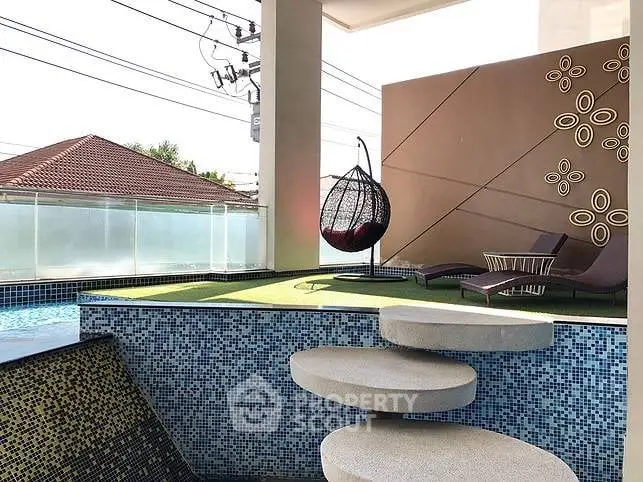 Luxurious rooftop pool area with modern design and stylish lounge chairs.