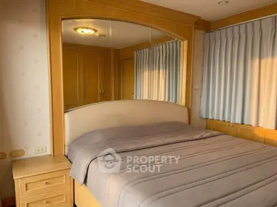 Cozy bedroom with wooden furnishings and ample natural light