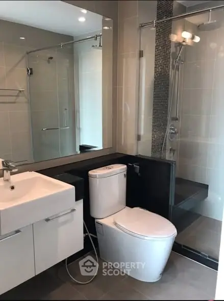Modern bathroom with sleek fixtures and a glass-enclosed shower