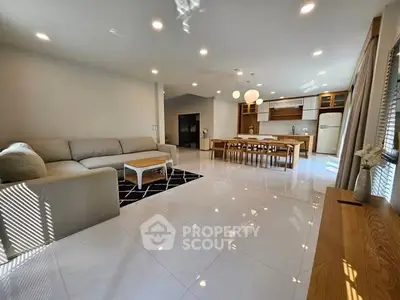 Spacious modern living room with open kitchen and elegant furnishings