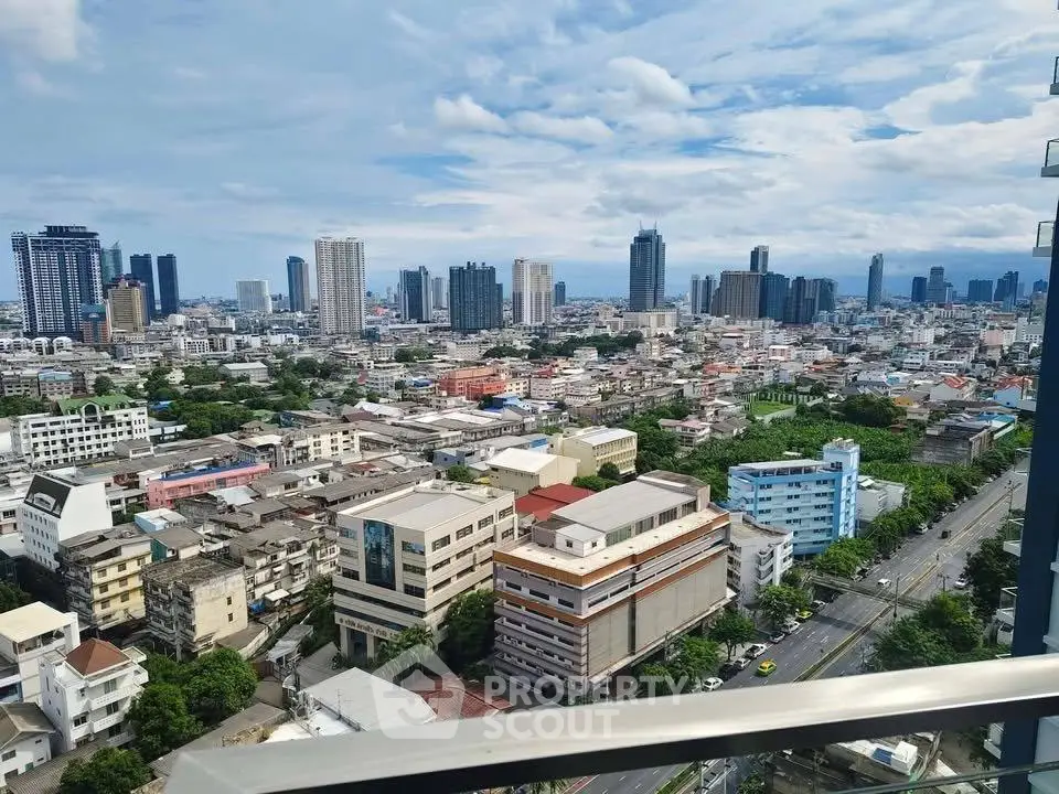 Stunning cityscape view from a high-rise balcony showcasing urban skyline and vibrant city life.